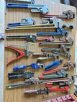 Full lot laid out on table showing quantity and size range of plumbing tools
