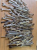 Pile of assorted wrenches spread on table