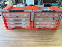 Front view of dual-sided red organizer with boxes inserted