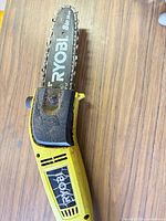 Close-up of guide bar and chain with Ryobi branding
