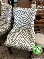 Front view of one zebra print chair showing upholstery, arms, legs