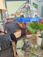 Full lamp showing stained glass shade and metal base