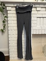 Front view of full-length gray ribbed leggings hanging