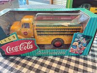 Front view of boxed yellow Coca-Cola die-cast delivery truck bank