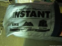 Bag showing 'NO ASSEMBLY REQUIRED INSTANT' and setup icons
