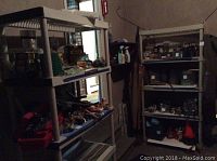 Two beige plastic shelving units shown indoor with various household items on shelves, visible wear noted.