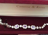 Bracelet laid out in velvet-lined box displaying amethyst and clear rhinestone design.