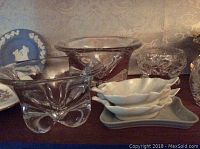 Assorted clear cut glassware, including bowls and dishes with intricate patterns