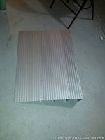 Top view of aluminum handicap ramp showing ribbed texture surface and rectangular shape.