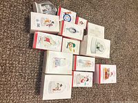 Group shot of all Hallmark Keepsake ornament boxes plus loose snow globe
