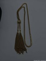Full necklace laid flat showing both tassel ends