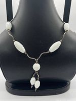 Necklace displayed on bust showing bead arrangement and drop