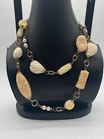 Necklace displayed on bust showing bead variety and length