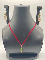 Necklace and earrings displayed on bust