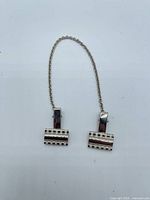 Full view of sweater clip showing chain and both rectangular clip ends