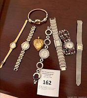 All eight watches laid out on tabletop