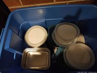 Blue tote containing multiple stainless steel containers with assorted lids