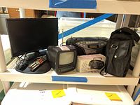 Group shot showing Sceptre LCD TV, CRT TV, JVC boombox, Hisonic bag and remotes