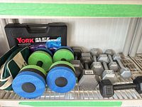 Shelf with York fitbells case, neoprene zip bag and multiple dumbbells