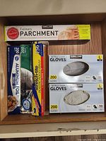 All five containers: parchment, foil, plastic wrap, two glove boxes