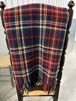 Full view of tartan plaid throw draped on chair