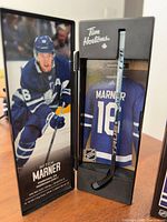 Mini stick inside display case beside player image panel
