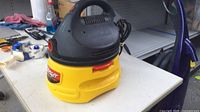 Front left view of Stinger wet/dry vacuum showing carry handle and power cord