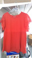 Front view showing full red top on hanger