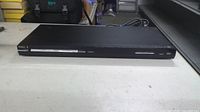 Front view of Philips slim black DVD player