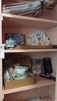 Shelf with all items including hex keys, paint palette, frame, stakes and hardware boxes