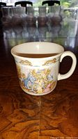 Front view showing Bunnykins christening scene on mug