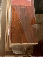 Top view of box showing Terra Cotta plank surface and torn plastic