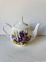 Full side view of teapot, showing floral design and overall form