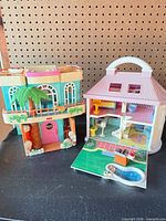 Both dollhouses front view side by side
