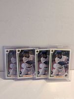 Front view of four Ken Griffey Jr. Upper Deck #555 cards in top loaders