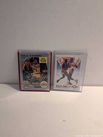 Front view of both sleeved cards showing player images and NBA Hoops branding