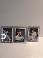 Front view of all three Topps baseball cards in top loaders