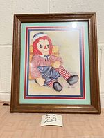 Front view showing Raggedy Andy print, mats and wood frame