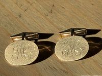 Front view of both cufflinks showing monogram and finish