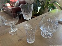 Four assorted crystal pieces on table