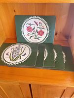 Front view of all six Portmeirion Botanic Garden placemats stacked with one displayed upright