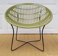 Front view of avocado green Solair chair showing seat perforations and base