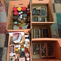 Four cardboard boxes filled with assorted fasteners, jars and dividers