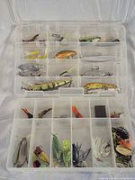 Open tackle box showing all compartments and assorted lures