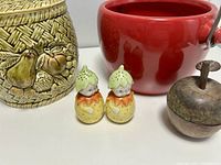 Group shot showing ceramic canister, red apple bucket, metal apple box, and salt & pepper shakers