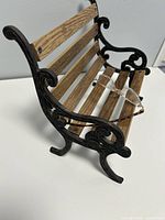 Side view showing cast iron scrollwork and wood slats