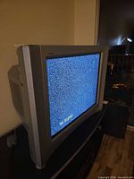 Side view of Sony 27-inch Trinitron CRT TV powered on showing static