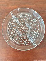 Top view of clear pressed glass divided platter showing starburst pattern