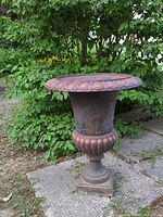 Full view of cast iron urn on square base