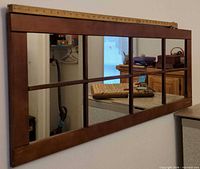 Front view of horizontal multi-pane wood wall mirror mounted on wall
